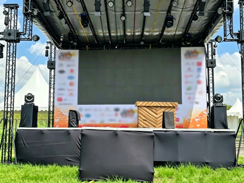 outdoor 8x8&times;6m lighting truss system installed on grass with slope roof